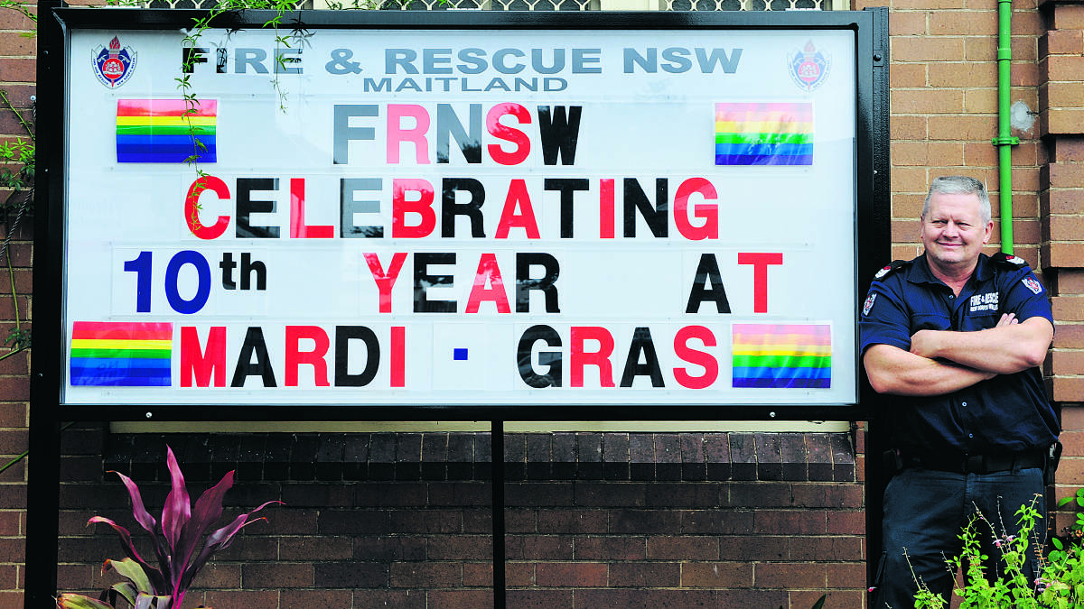 Firefigher Mark Goffett with the Maitland fire station’s message of support for Mardi Gras. 
