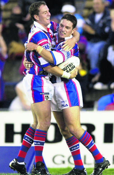 GREAT MEMORIES:  Mark Hughes and Danny Buderus celebrate a try during their playing days.