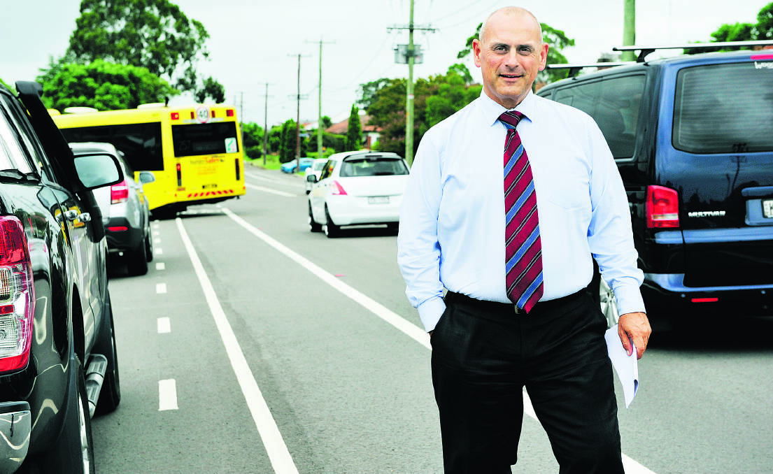Steve Thomson stands on a busy Lindesay Street, East Maitland. 