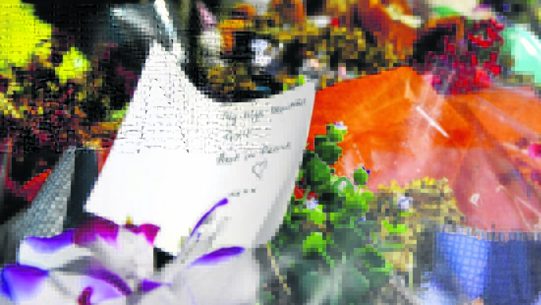 TRIBUTES: Some of the ­flowers and tributes left outside the dead girl’s home over the holiday period. Pictures by PERRY DUFFIN