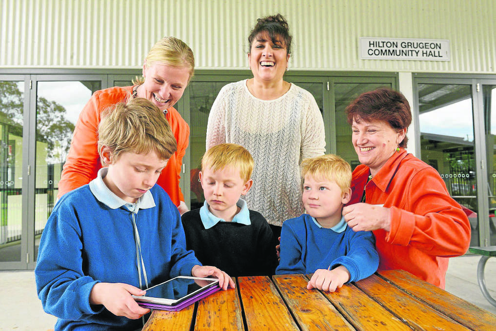 LEARNING TOOLS: Aspect Hunter students Joe Austin, Charles Hipps and Lachlan Taylor with assistant principal Amy Kennedy (left), Jane Reeves (right) and CUA Regional Media and Community Co-Ordinator Natalie Ephraums. 	Picture by STUART SCOTT