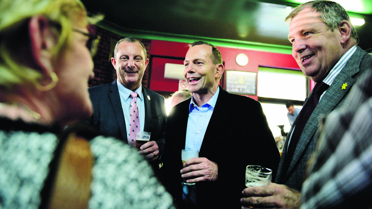 TONY’S SHOUT:  Prime Minister Tony Abbott and Paterson MP Bob Baldwin share a beer with locals at The Bank Hotel.	Picture by PERRY DUFFIN 