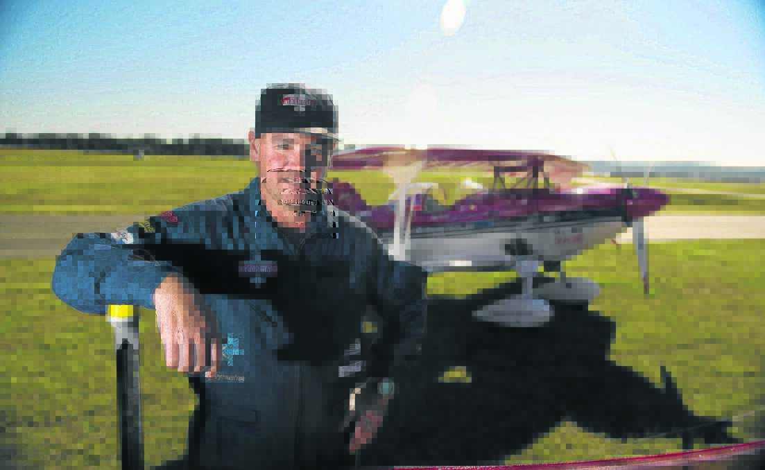 EXTRAORDINARY PILOT: Leading stunt pilot Paul Bennet flew his plane under a motorcycle as it glided over a jump.  
