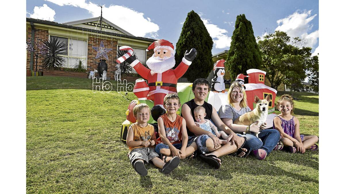 EXCITED:  Cohen Hall, Logan Hall, Tyson Miller with baby Darci Hall, Maddison Bice and Makenna Hallett with the Bice family’s Christmas display. 	Picture by PERRY DUFFIN 