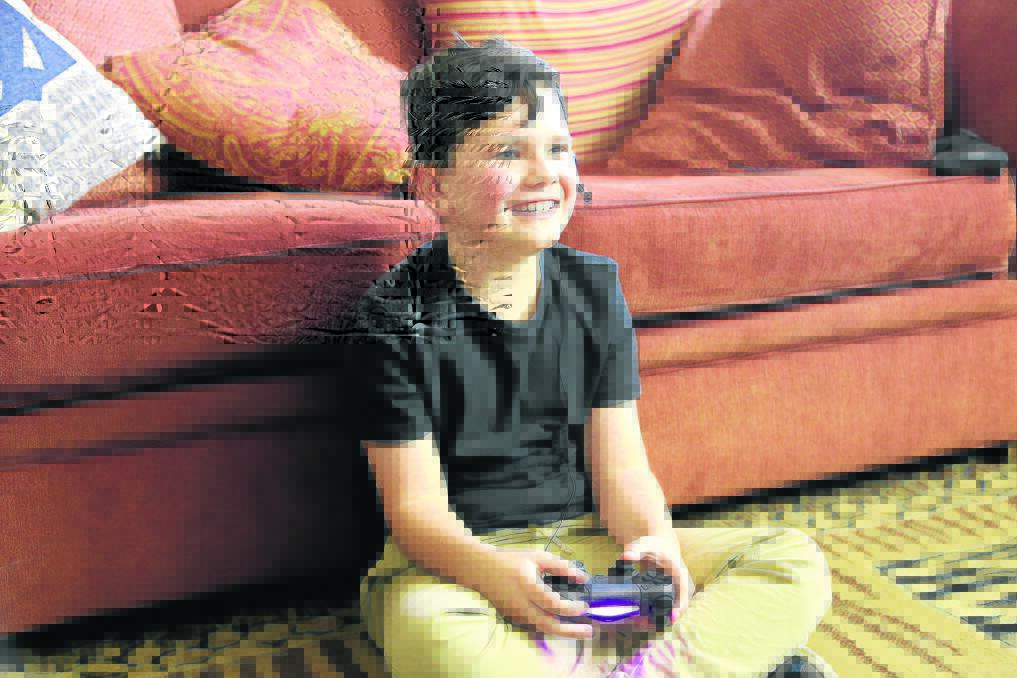 UP SIDE: Mark McGlinn says his son Brett, who has autism, is more confident and it's all down to online video games. 	