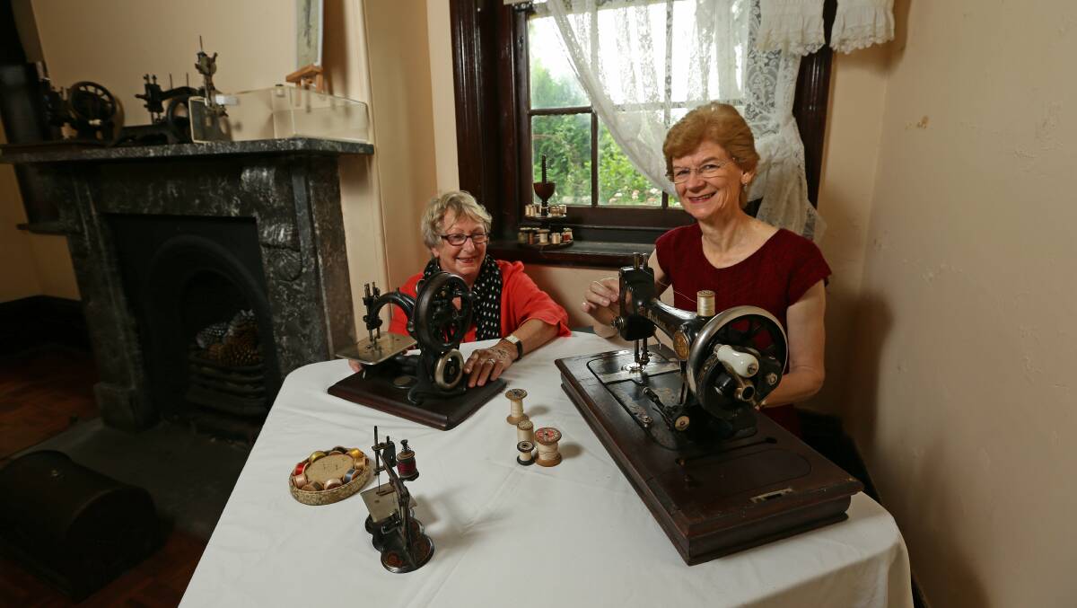 IN STITCHES: Committee members Holly McNamee and Lynn Morris with two of the old sewing machines. 	Picture Jonathan Carroll