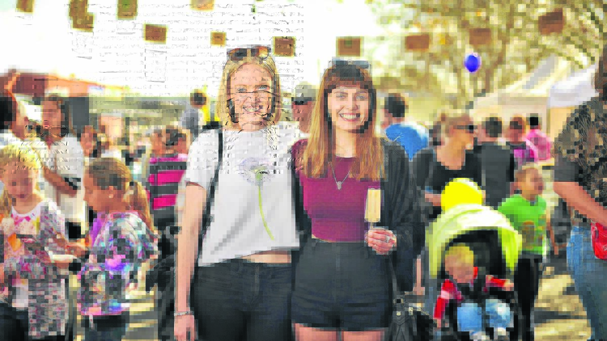 SMILES ALL ROUND: Emily Pullbrook of Ashtonfield and Teagan Seymour of Cooks Hill soaking up the sunshine. 	Picture by PERRY DUFFIN 