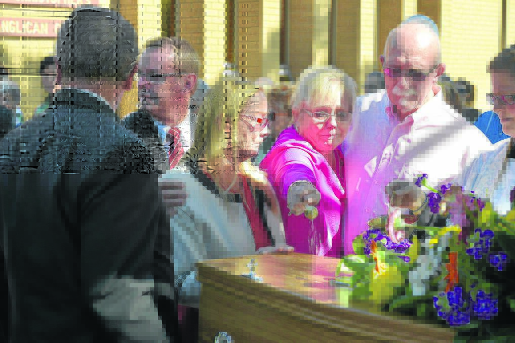 LAST GOODBYE:  Mourners fight back tears after yesterday’s funeral for popular great-grandmother Anne Jarmain.  	Picture by STUART SCOTT 