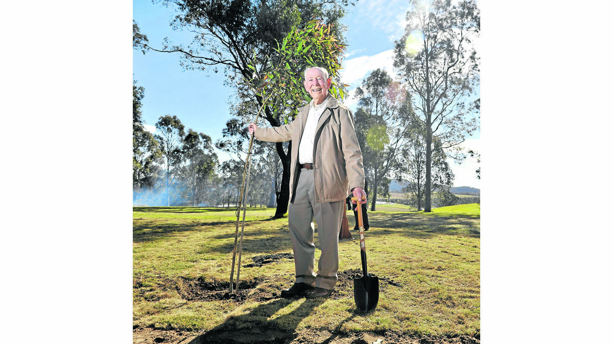 50 YEARS: The first principal of Tocal College Colin Ford plants a tree to commemorate the first 50 years of agricultural college.