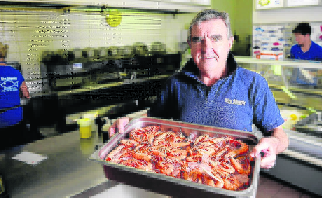 COME AND GET ’EM: Graham Rutter of Sea Shanty Rutherford with a tray of fresh prawns. 	Picture PERRY DUFFIN 