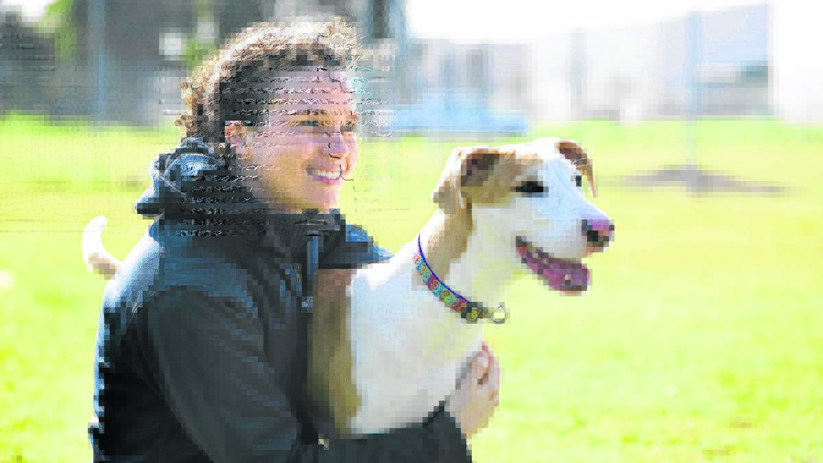 SMILES ALL ROUND:  RSPCA spokeswoman Jess Conway with Lucky, who is a picture of health.	Picture by PERRY DUFFIN 