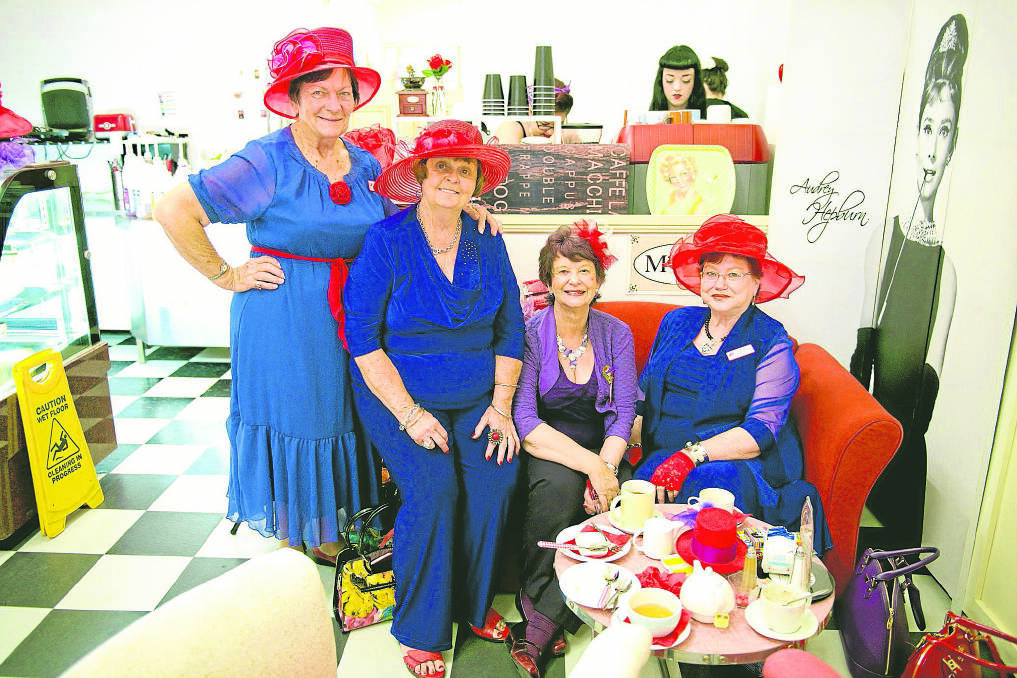 RED HATS GALORE: Red Hat Society members Margaret Nisbet of Croudace Bay, Jan O’Loughlin of Teralba, Pauline Elsley of Speers Point and Dianne Grasso of Caves Beach.  	Picture by PERRY DUFFIN 