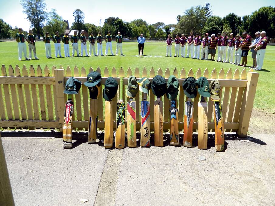 MARK OF RESPECT:  First grade cricketers pause for Phil Hughes at Robins Oval last year. 	Picture by ERIN WILSON