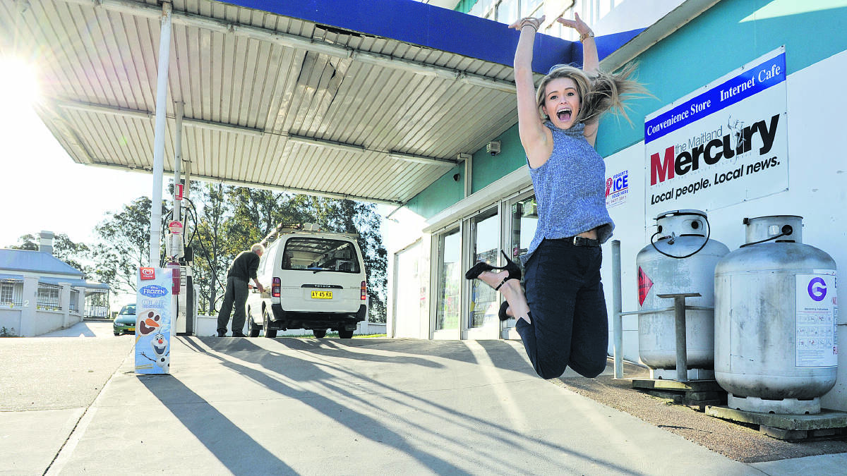 WHAT A FEELING:  Maitland motorists including Abby Thorne are celebrating at the fuel pump with the Mercury’s and NRMA’s campaign leading to the city having the cheapest ­average unleaded fuel price in NSW last week.  	Picture by CATH BOWEN