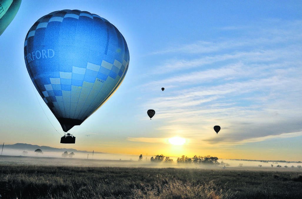 PERFECT DAY: Sunrises as hot-air balloons lift off in the Hunter Valley Balloon Fiesta. Picture by HOWARD ARCHBOLD/WINEPIX