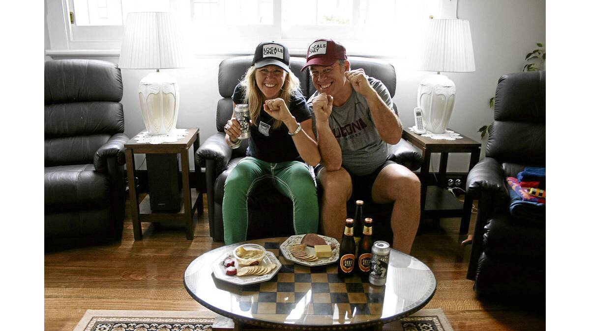 GAME FACES:  Vermont natives Heather and Bob Henderson are happy to be enjoying their Super Bowl ritual in Australia.
Picture by JOSH CALLINAN