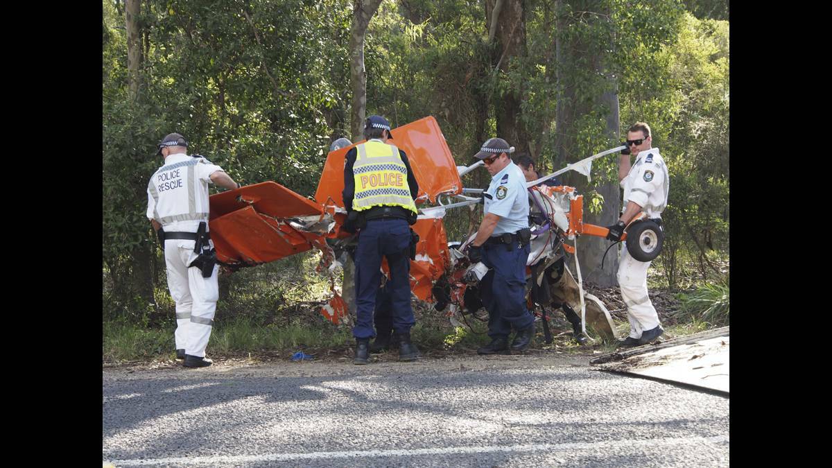 LOVEDALE PLANE CRASH: The remains of the plane are removed from the paddock by police.