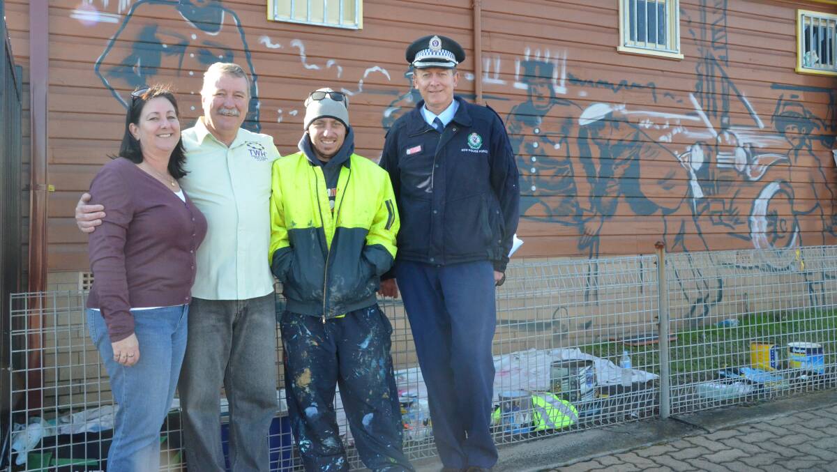 COMMUNITY HISTORY: Towns with Heart community projects manager Lesley Morris, Towns with Heart mural guide Matt Nolan, artist Ben Mellon and Inspector Glenn Blain at the site of the new mural at Kurri Kurri police station.