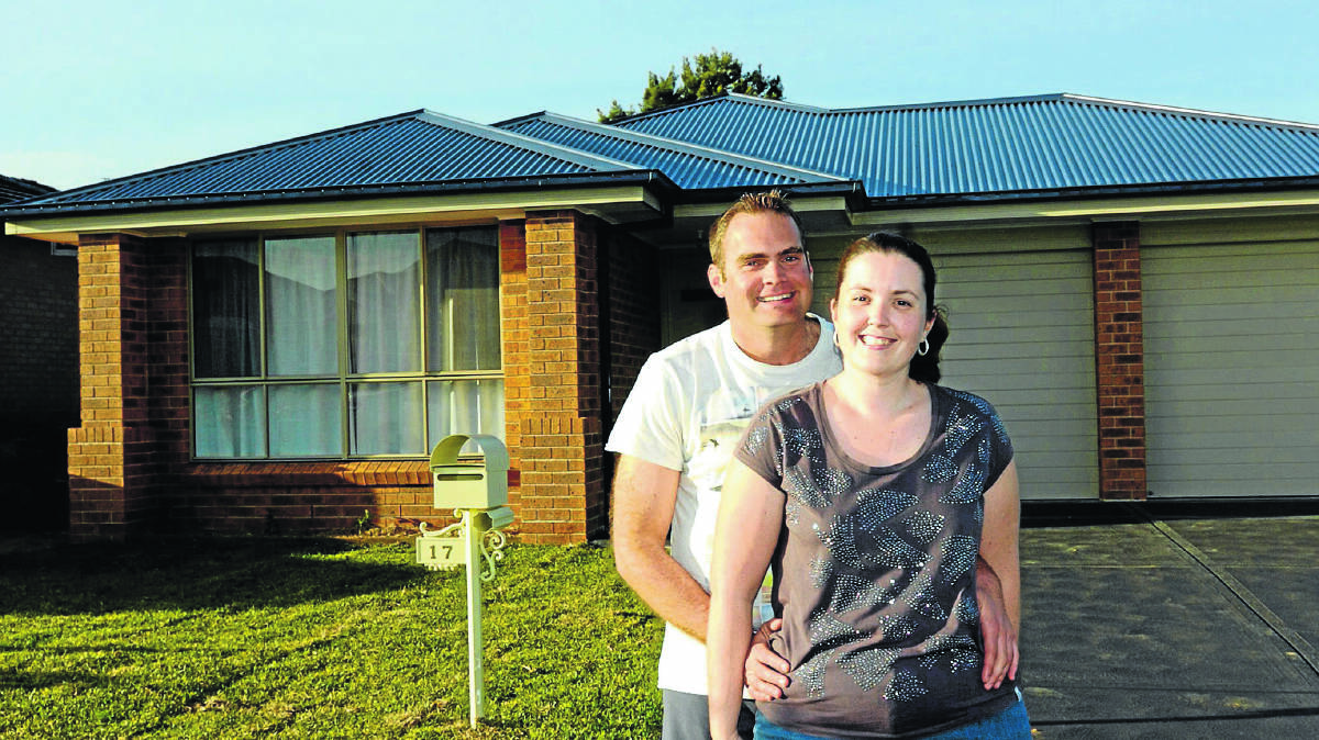NEW HOME: Clinton Modinger and Melissa Taylor outside their new home in the Wallis Creek housing estate at Gillieston Heights.  	Picture by STUART SCOTT