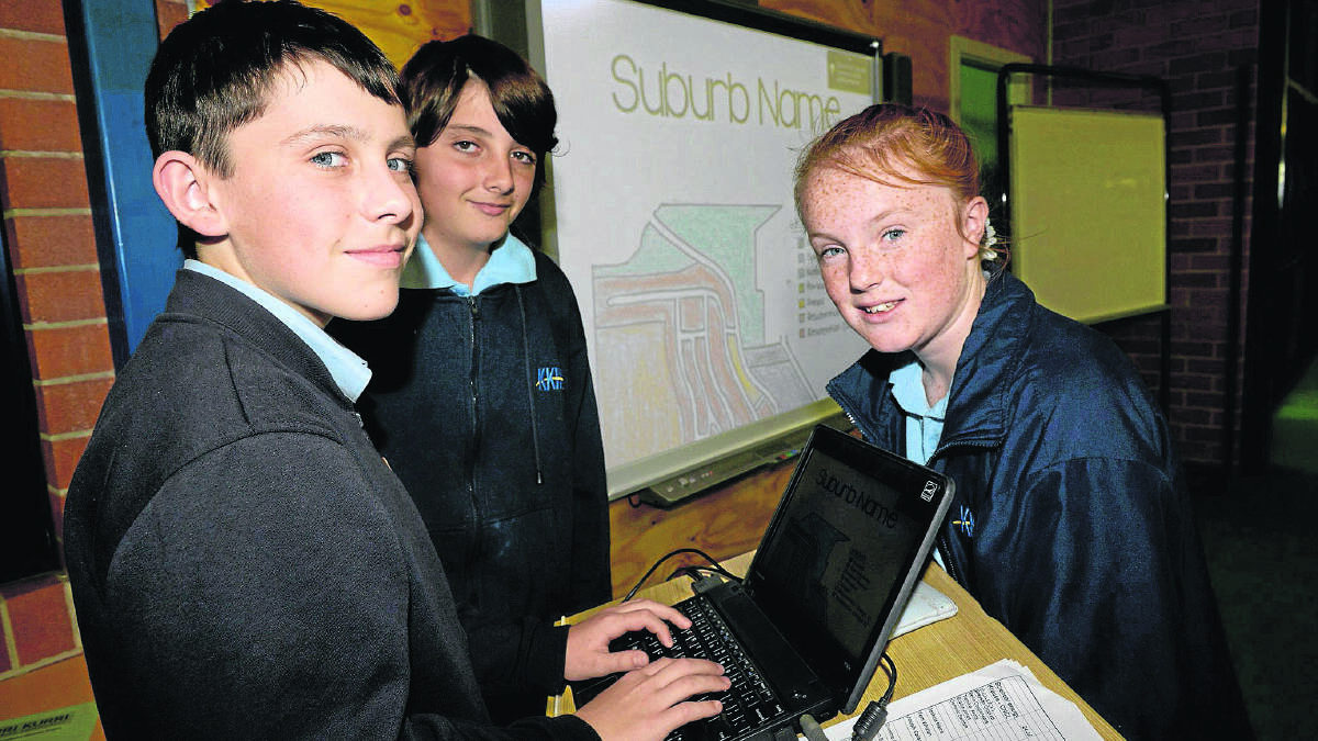 PLANNING STAGES: Kurri Kurri High School students Noah Jeffries, Logan Connolly and Emma-Lee Green work on their  virtual subdivision project as part of Education Week celebrations.  
