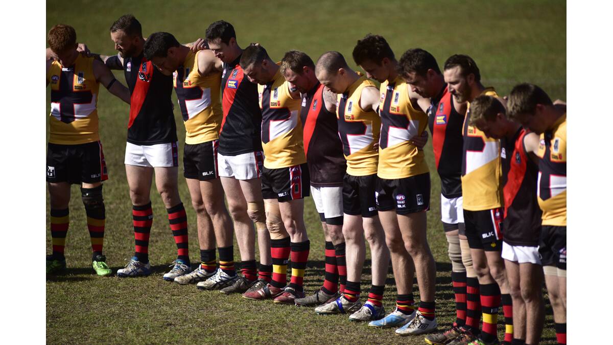 WALSH TRIBUTE:  Maitland Saints and Killarney Vale players join in a ­tribute to murdered AFL coach Phil Walsh.
