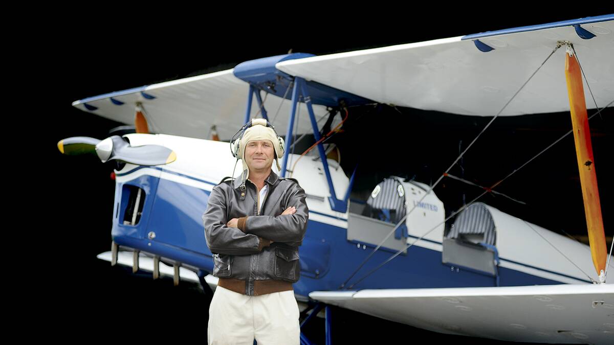 MILESTONE:  Hunter Valley Vintage Wings owner Ben Merkenhof with one of his company’s two Tiger Moths which mark 75 years of service this year.	Picture by CATH BOWEN 