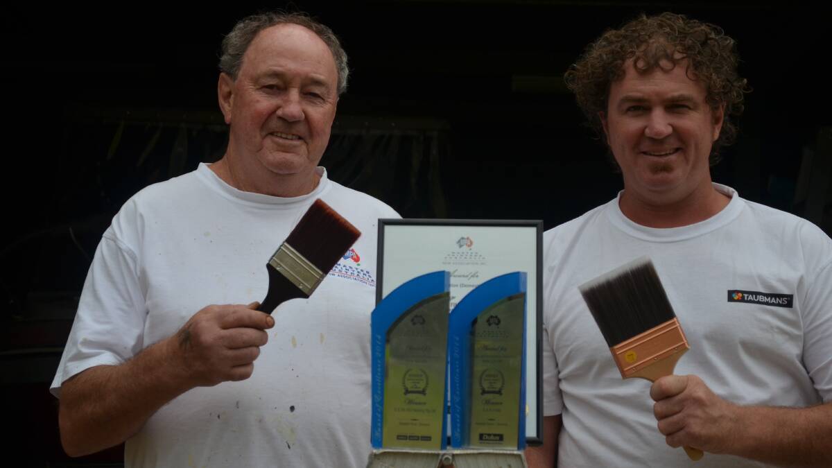 HERITAGE OF SUCCESS:  Graham and Craig Hill with the awards their company 
has received during 2014.  	