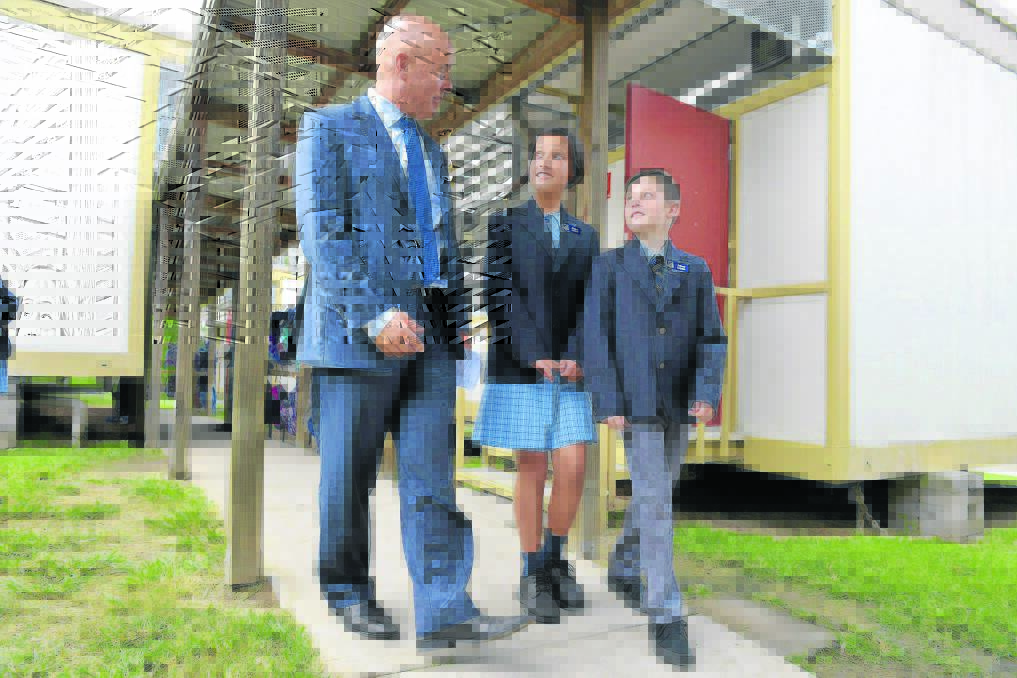 WELCOME VISIT:  Education Minister Adrian Piccoli is taken on a tour of Bolwarra Public School by school captains Myra Paleologos and Olly Latter. 	Picture by STUART SCOTT
