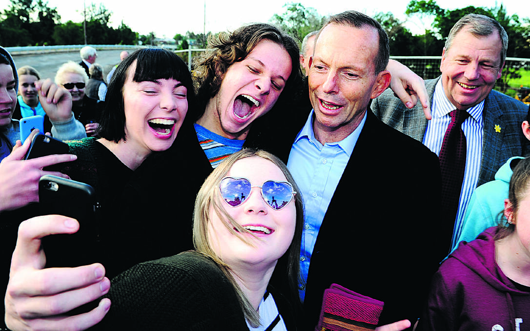 ROCK STAR WELCOME:  Prime Minister Tony Abbott poses with young fans keen to record their brush with fame.