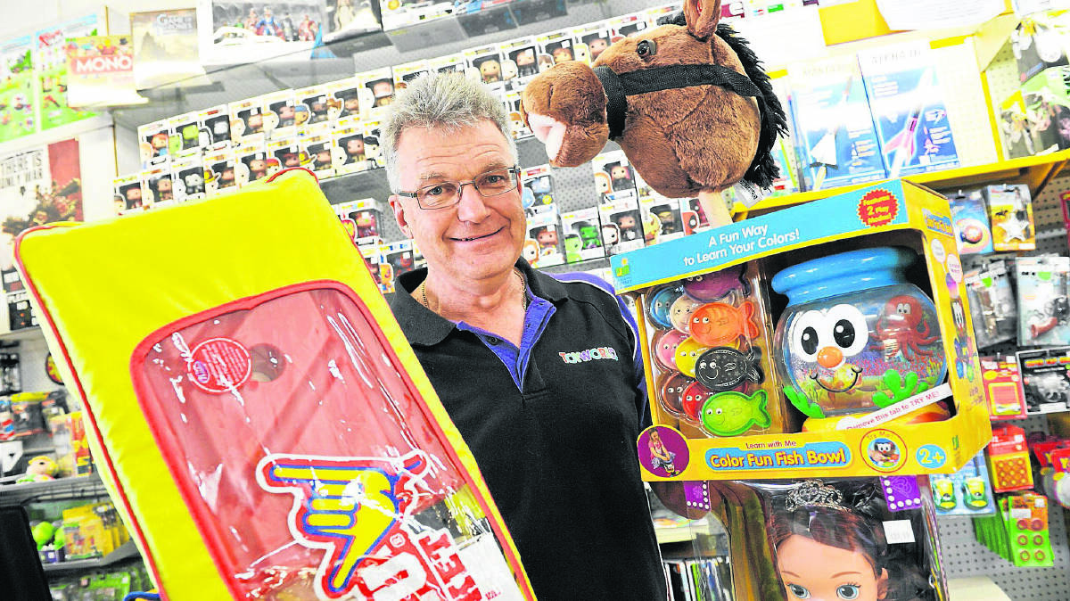 GOOD CHEER:  Maitland Toyworld’s Gareth Rodgers with some of the popular toys up for grabs in the Mercury Christmas Toy Promotion  	Picture by STUART SCOTT