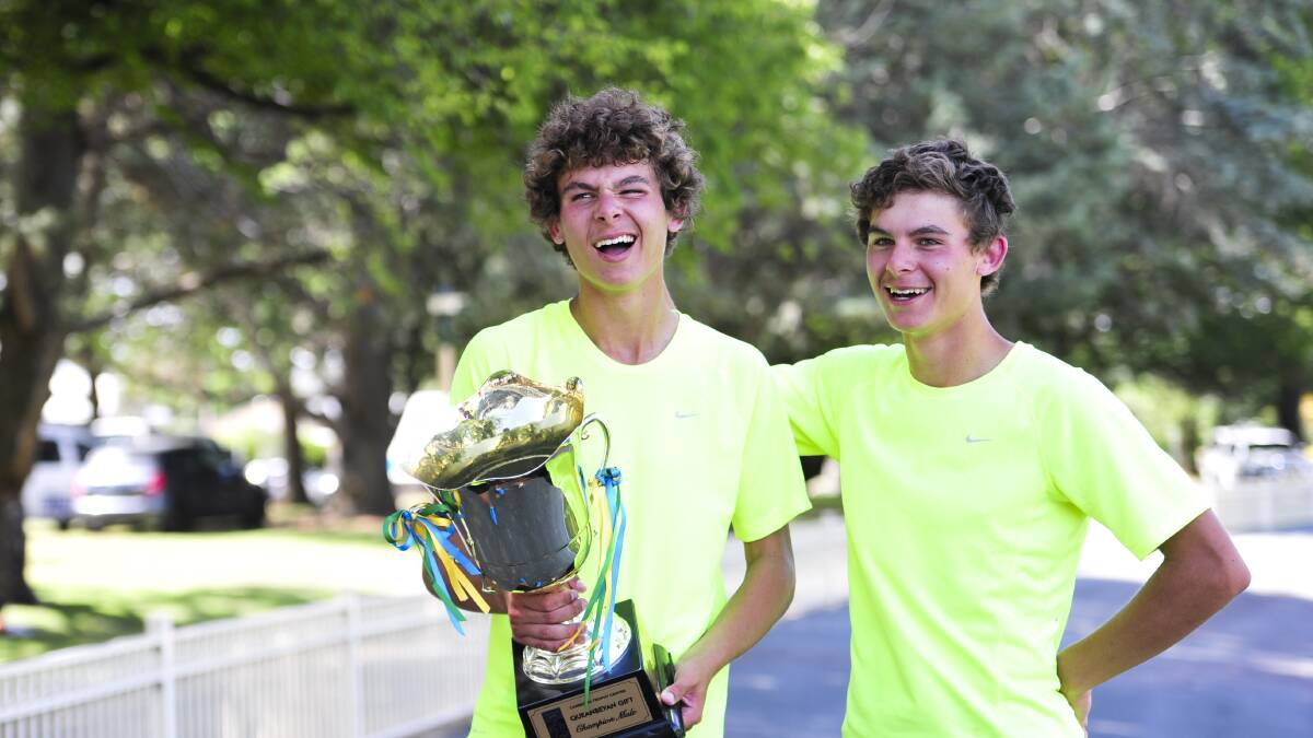 IT’S A GIFT:  Queanbeyan Gift winner Tom Newman holds his ­trophy next to twin brother Jack, who ran second in the prestigious race.