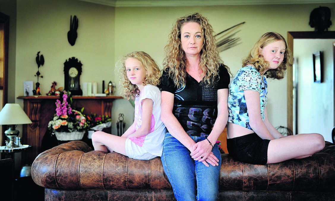 PICKING UP THE PIECES:  Mum Jane Richardson with Milly’s sisters Ivy, 10, and Piper,13.
  	Picture by CATH BOWEN