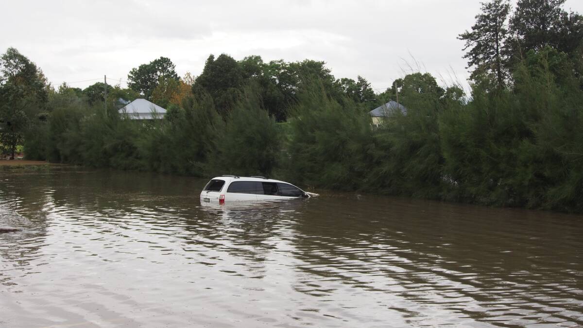 CAUGHT OUT:  This car in a central Maitland car park was left stranded when the water rose and is still stuck there on Monday. 	Picture by NICK BIELBY