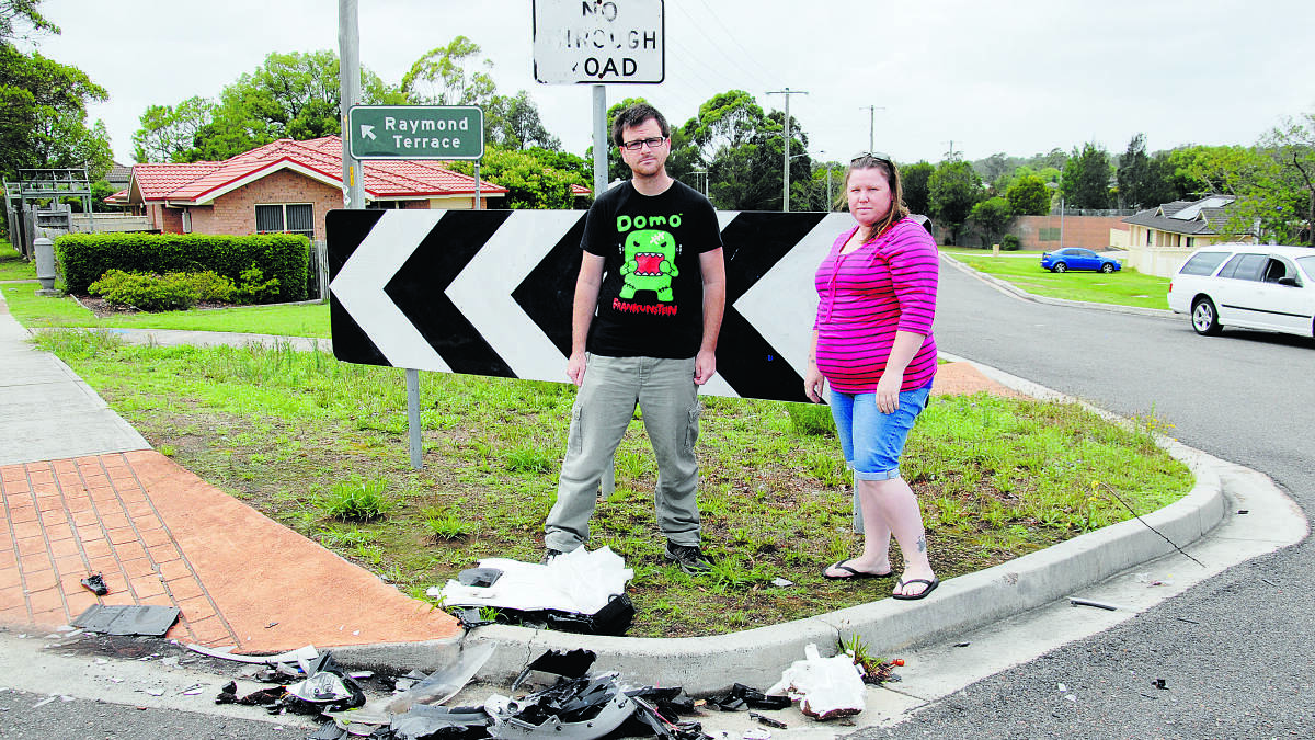 HEAD-ON CRASH:  Gary Hope and Amanda Moult at the scene of a head-on crash at the intersection of Raymond Terrace Road and Lindsay Street last week.	Picture by ALAN HARDIE.