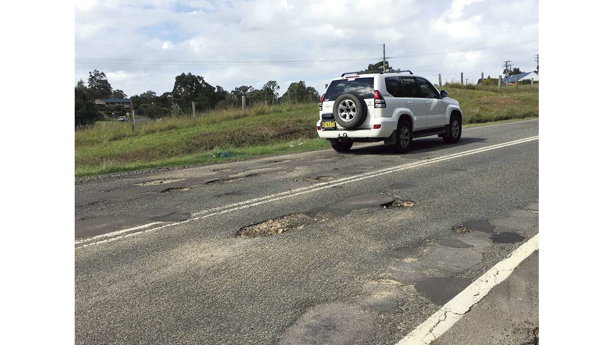 POTHOLES: The road under Farley Bridge was scarred with significant potholes in both directions yesterday. Picture by NICK BIELBY