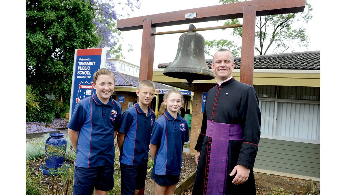 HISTORIC GIFT:  Father David Battrick of St Peter’s Anglican Church East Maitland with Tenambit Public School leaders Cameron Pannowitz, Zaine Botham and Skye Armstrong.  	Picture by CATH BOWEN  