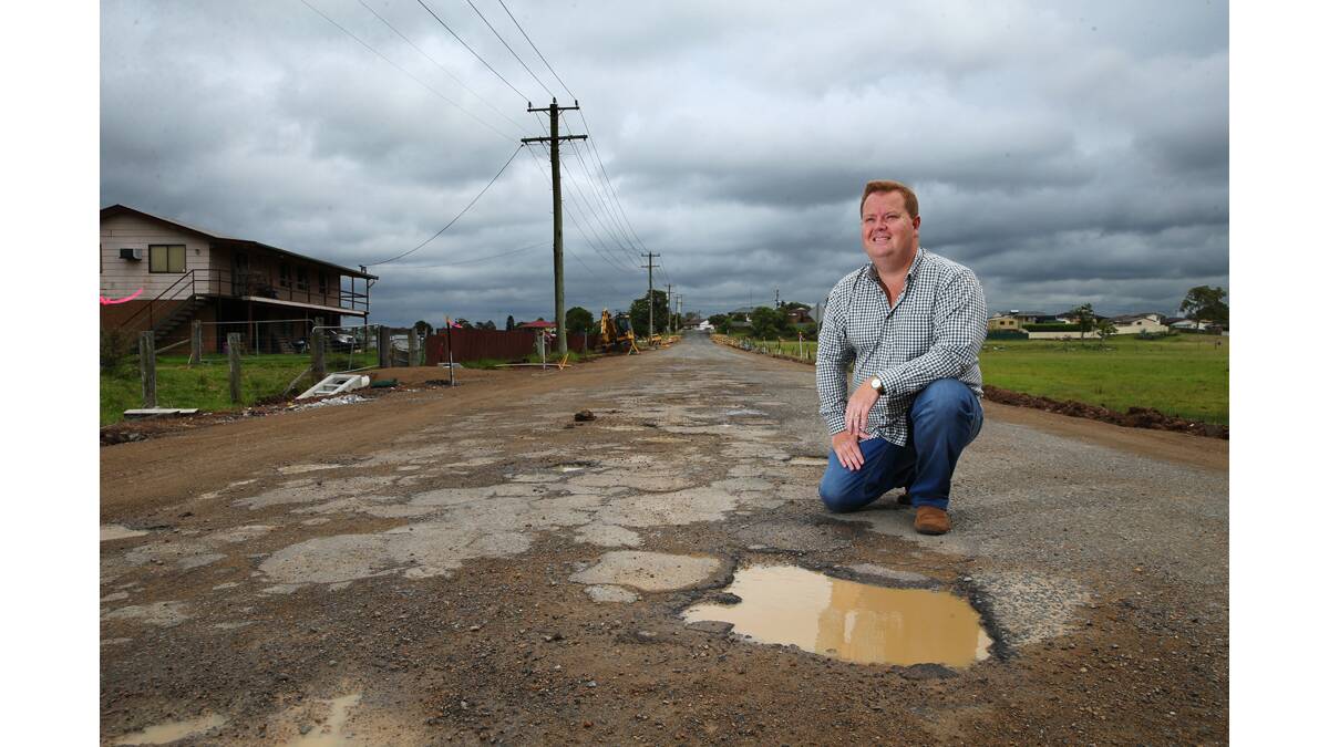 REPAIRS: Maitland councillor Philip Penfold shows some of the damage to Redbill Drive.  	Picture by MAX MASON-HUBERS