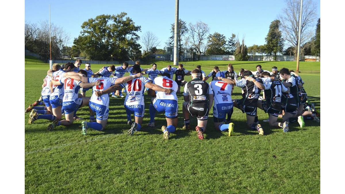 TAKING A KNEE:  Maitland Pickers and Central Newcastle players pay tribute to James Ackerman, who died after being tackled in a match on the Sunshine Coast in Queensland.