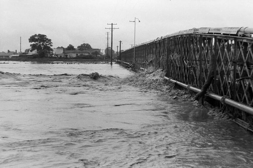 FEARSOME:  Floodwaters barrage a bridge with debris. 