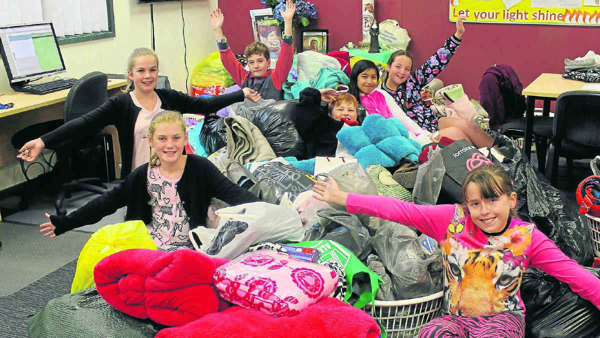 FOR CHARITY:  Kids from St Paul’s Rutherford pose with their donations.  	