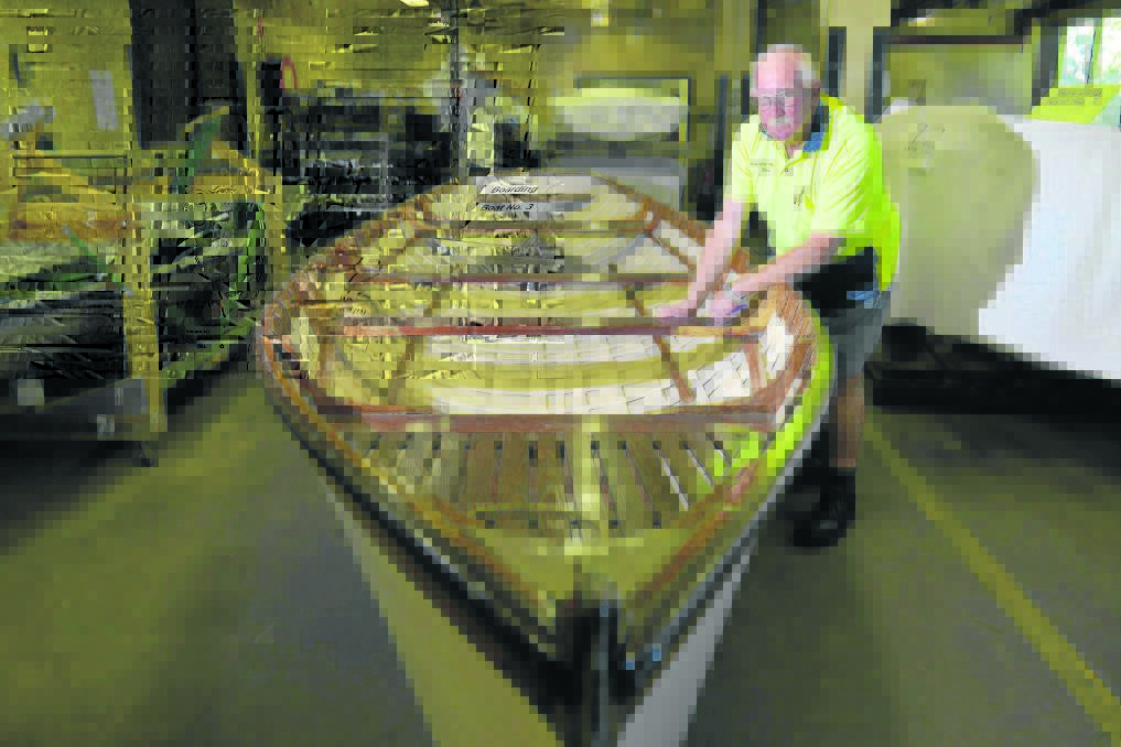 ON DISPLAY:  Bill Storer with the restored flood boat.   	Picture by
STUART SCOTT