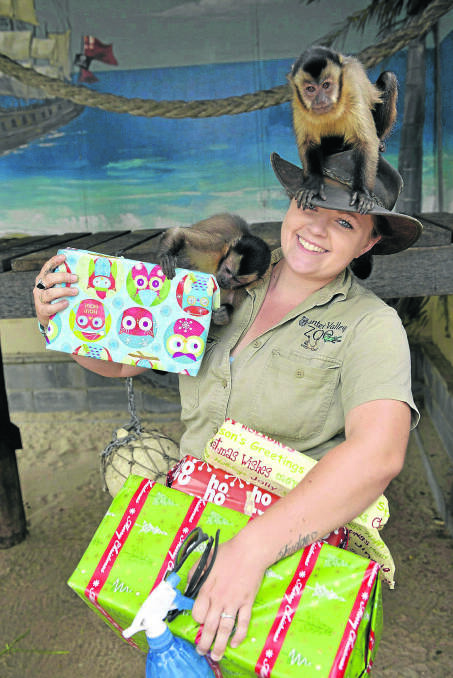 EAGER: Hunter Valley Zoo primate keeper Daisy Hawkins with a couple of her charges.