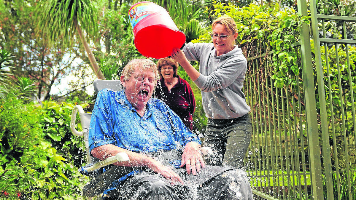 FOR A GOOD CAUSE: Malcolm Buck grimaces as a bucket of ice and water is tipped on him during the ice bucket challenge on Thursday. Picture by LACHIE CAWSEY