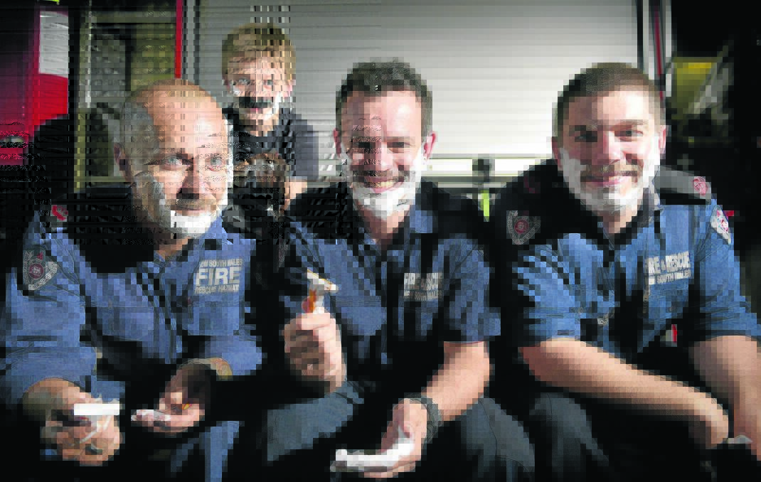 HAIRY RELIEF: Young Oliver Lancaster joined in the fun, but it will be a few years yet before he knows the relief ­experienced by Maitland firefighters Darren Lancaster, Dan Coutts and Nathan Crotty as they finally got to shave off their Movember moustaches. Picture by PERRY DUFFIN