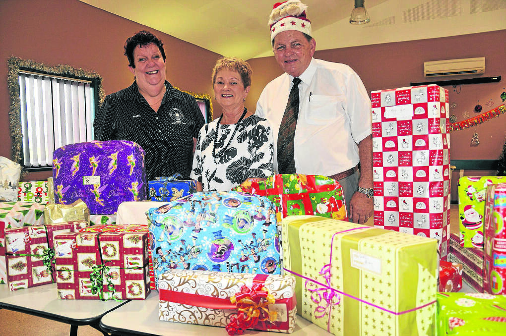 GOOD CHEER:  Maitland Neighbourhood Centre manager Naomi Rees (left) with Robyn Blackmore and the mayor of Maitland, Peter Blackmore and some of the gifts provided by council and its employees.	