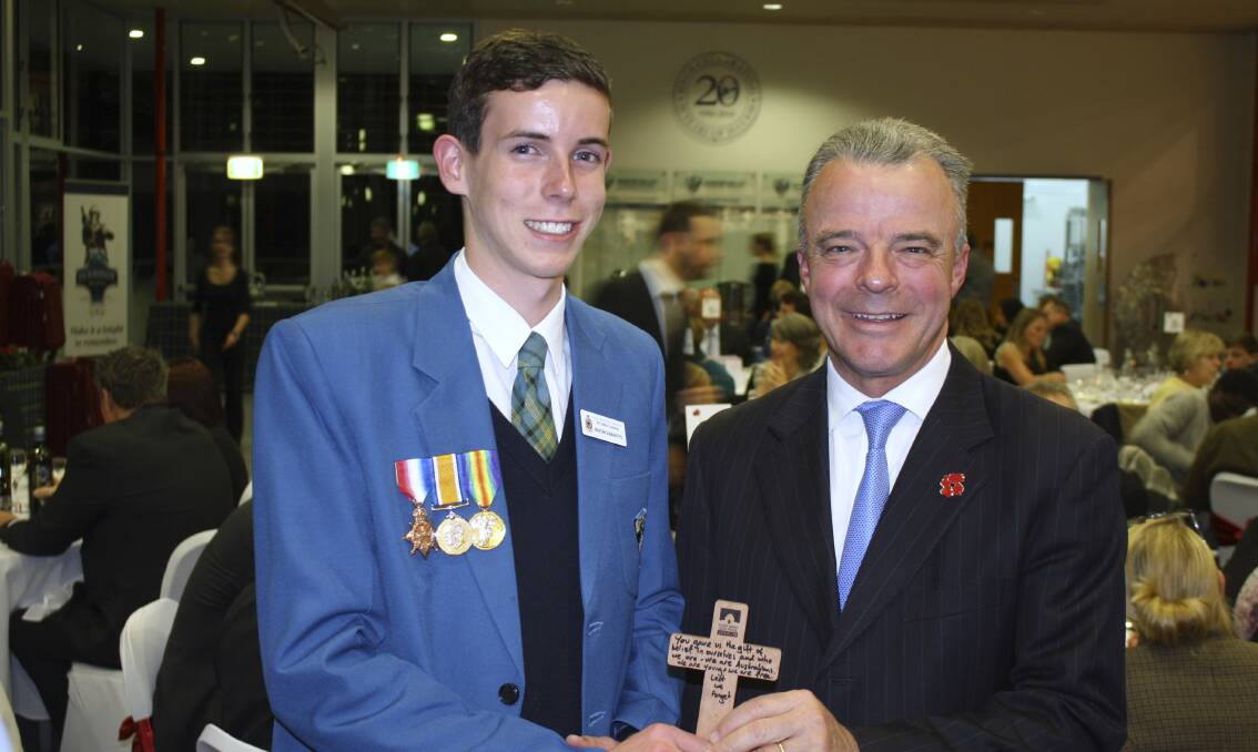 WWI CENTENARY:  Australian War Memorial director Brendan Nelson presents Brayden Duignan-Teys with the cross.  	