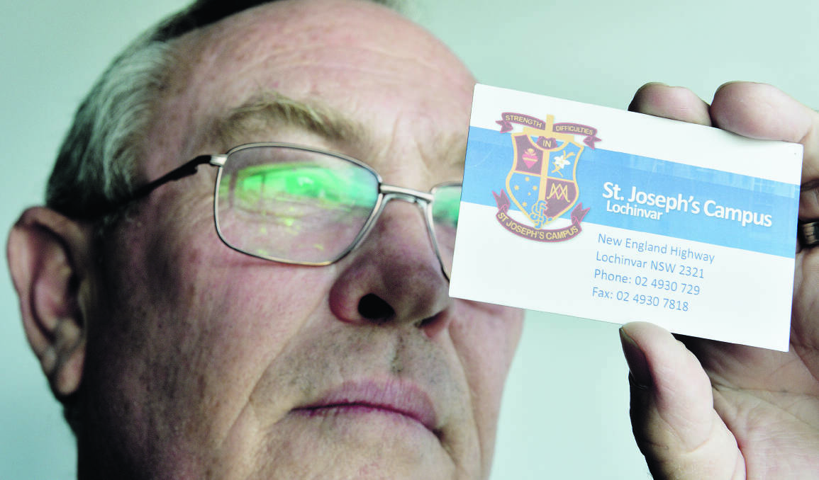 EMERGENCY NUMBERS: Maitland Suicide Prevention Network chairman Steve Schumacher with one of the cards distributed to students at All Saints College, St Joseph’s Campus, Lochinvar.  	Picture by CATH BOWEN