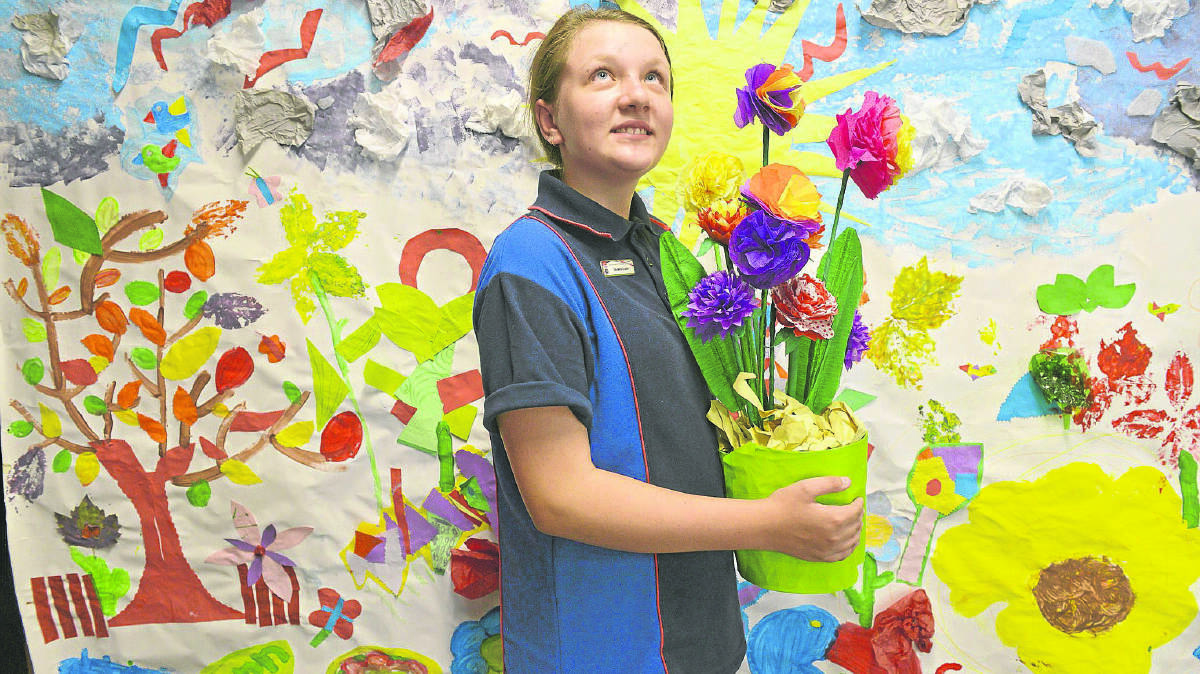 GARDEN SHOW:  Year 6 Tenambit Public School student Journey Keasey with some of the ­students’ ­artwork.  	Picture by STUART SCOTT 