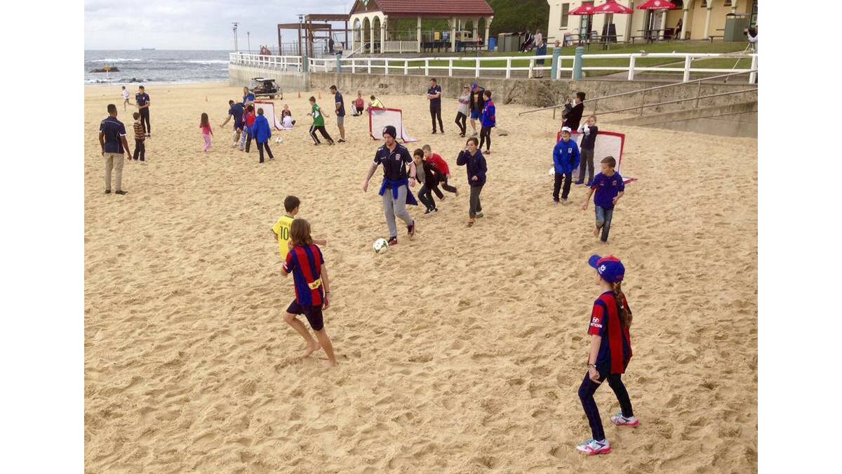 GRASSROOTS: Newcastle Jets players join in a beach football game with fans at Nobbys.