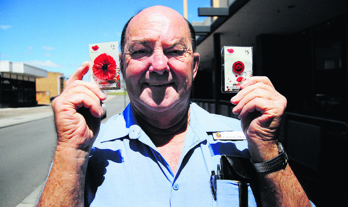 POPPY CONCERNS: Maitland RSL sub-branch vice-president Fred Goode with a couple of the Remembrance Day poppies. He is concerned the money from the sale of poppies at Woolworths will not be used in the district.